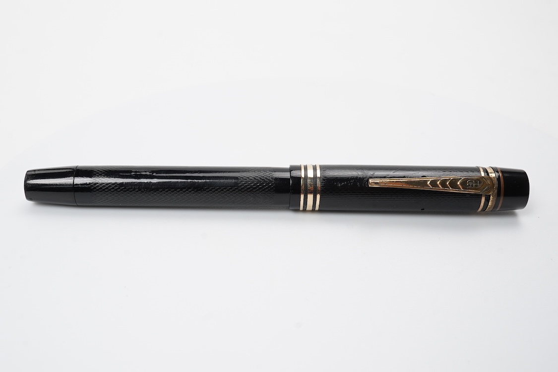A De la Rue Onoto piston fill fountain pen in large size with ornate cap banding and fitted with DLR Onoto No.5 14ct. nib